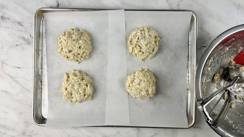 Uncooked crab cakes on baking sheet