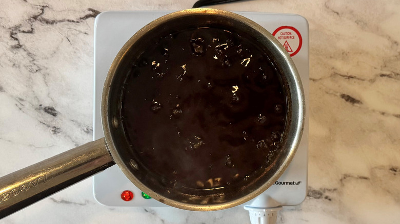 brown liquid in a metal pot on a hot plate