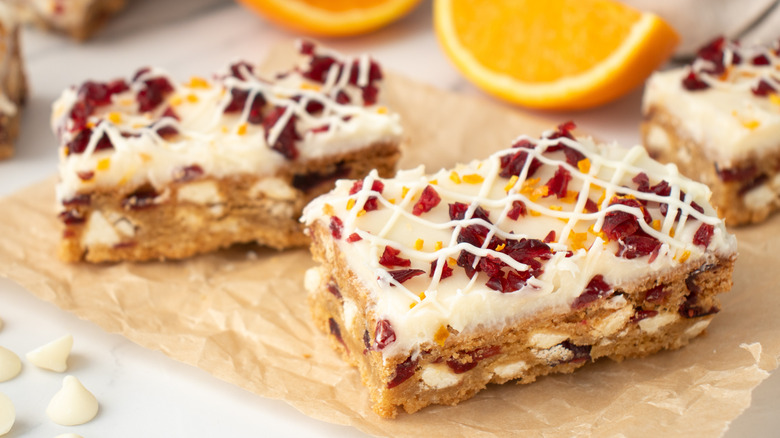 bar cookies with white frosting topped with cranberries