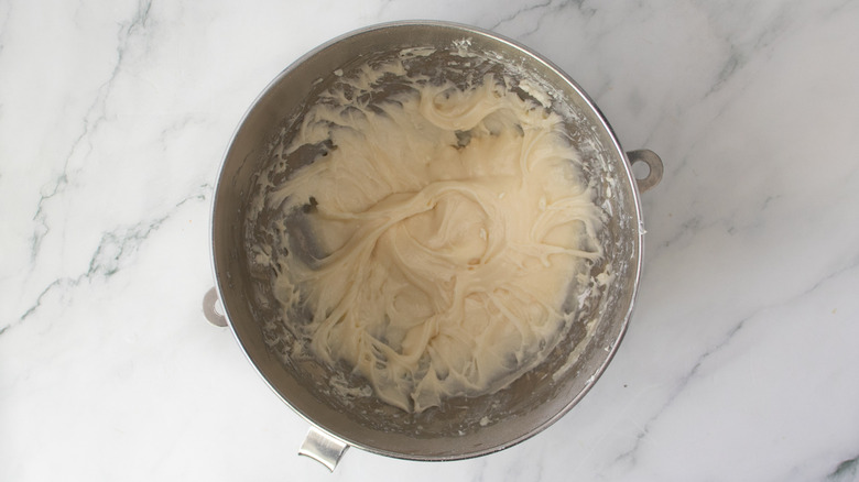 white frosting in a metal bowl
