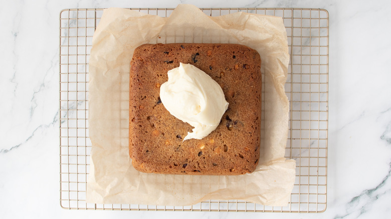 blob of white frosting on an uncut bar cookie