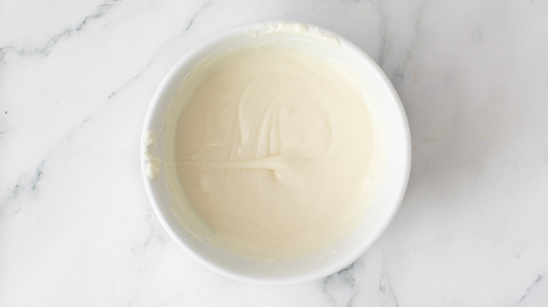 melted white chocolate chips in a white bowl