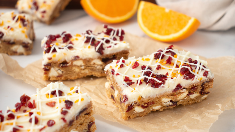 bar cookies with white frosting topped with cranberries