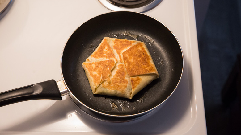 toasted Crunchwrap in nonstick pan