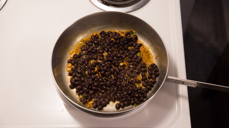 beans simmering in metal pan