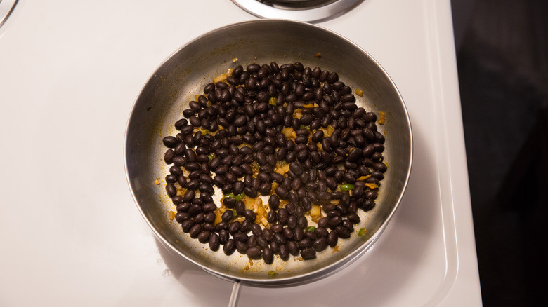 black beans simmering in pan