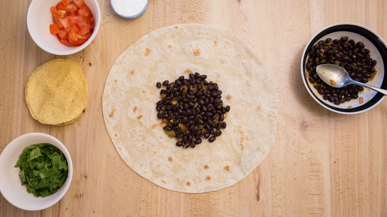 beans centered in flour tortilla