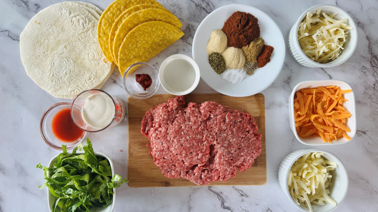 ground beef, tortilla, cheese, lettuce, seasonings, and condiments