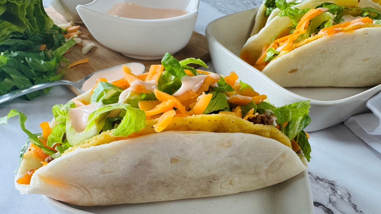 tortilla-wrapped taco in a square white bowl