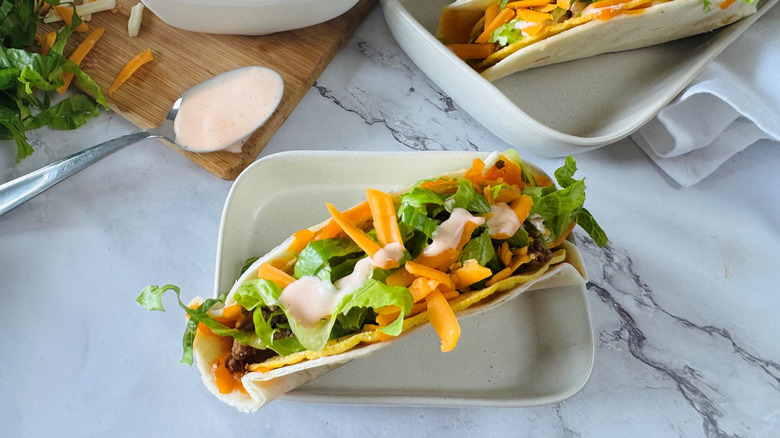 tortilla-wrapped taco in a square white bowl