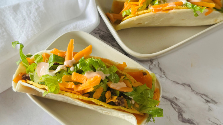 tortilla-wrapped taco in a square white bowl