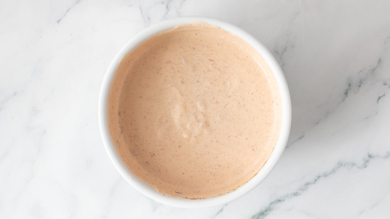 creamy pinkish-orange sauce in a white bowl