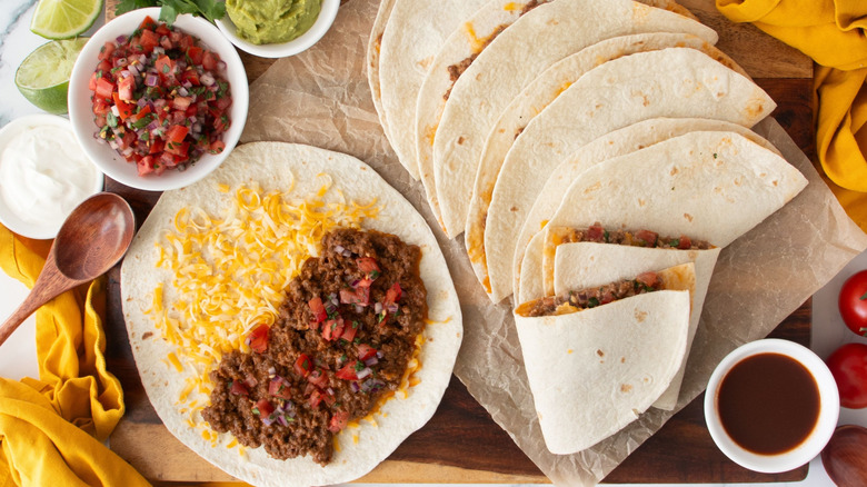 Taco Bell Meximelts surrounded by various toppings
