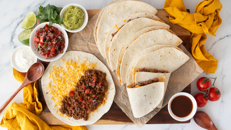 Taco Bell Meximelts surrounded by various toppings