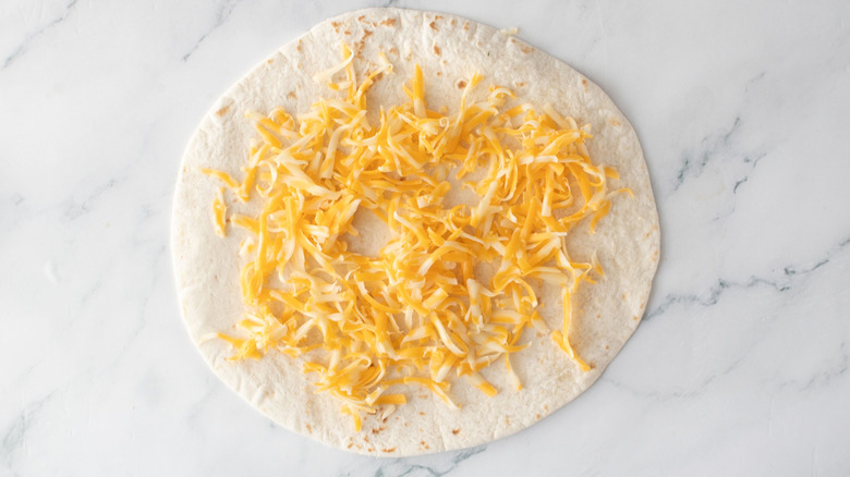 Flour tortilla sprinkled with cheese