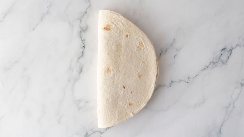 Folded tortilla on countertop