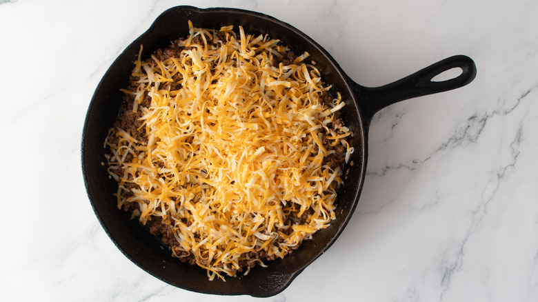 Shredded cheese in skillet