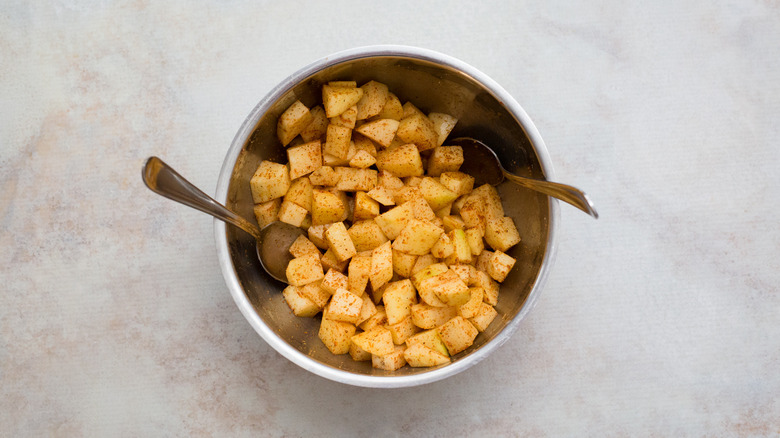 seasoned potatoes in mixing bowl