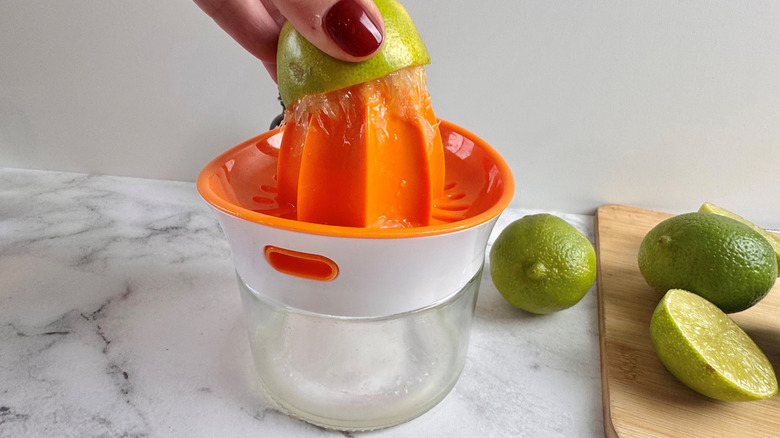 hand juicing a lime half