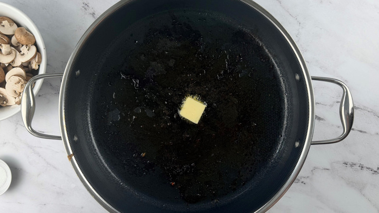 Pat of butter melting in pan