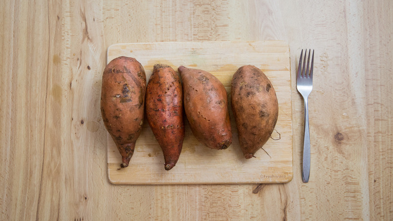 sweet potatoes on cutting board
