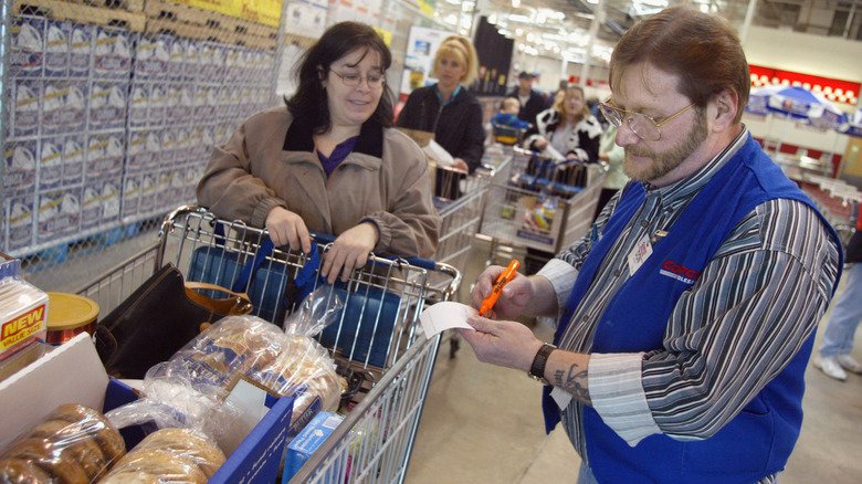 Costco worker checking receipt