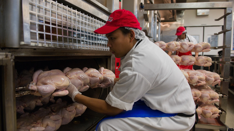 Costco deli worker in red hat with chickens