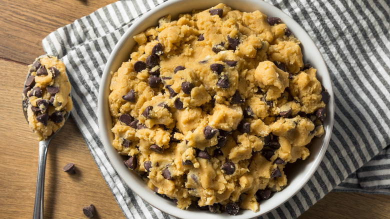 A bowl and spoonful of chocolate chip cookie dough