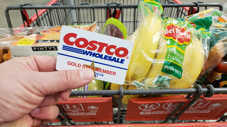 Costco card in front of grocery cart