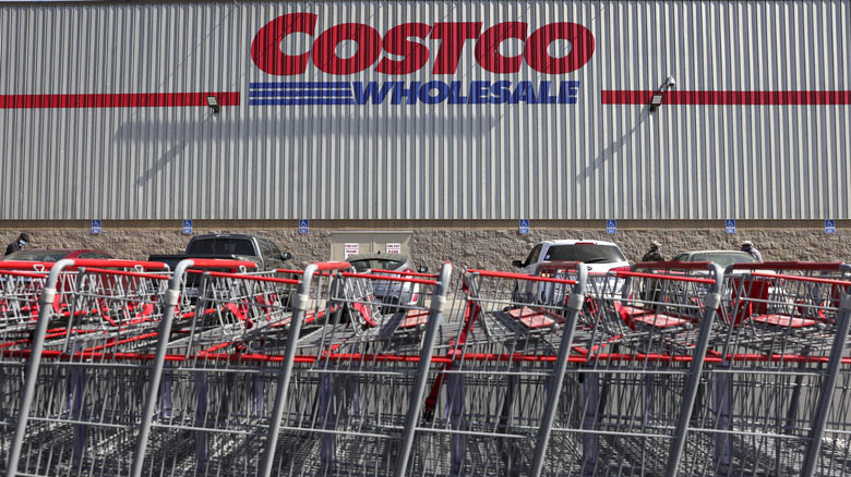 Costco logo on exterior building next to shopping carts