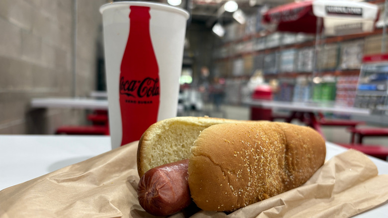 Hot dog and coca cola cup displayed on a table inside a Costco warehouse