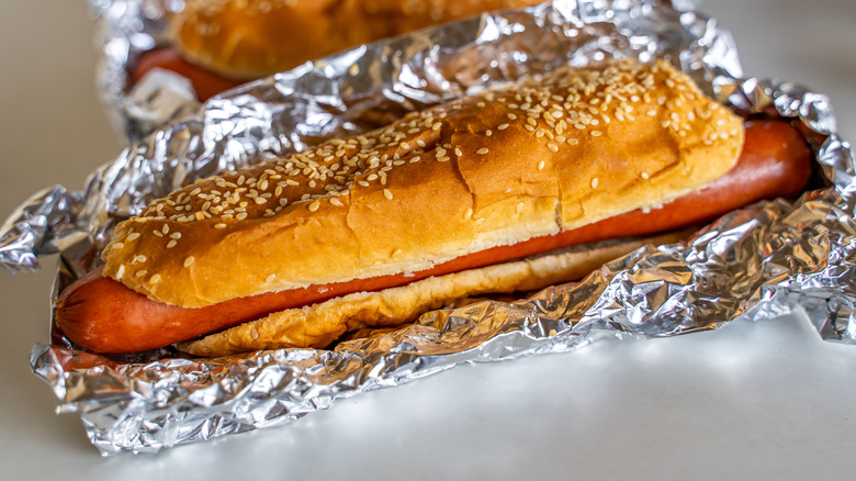 Costco hot dogs in foil on white plastic tabletop