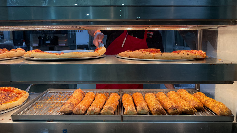Costco food court pizza under heat lamps.