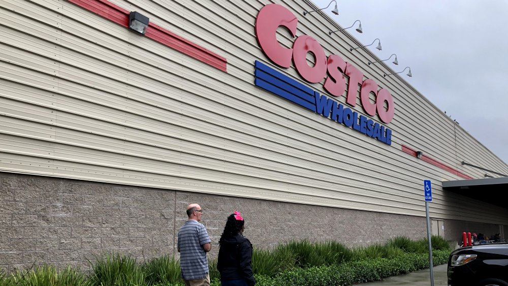 Two people walking into a Costco