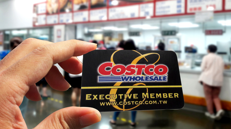 Person holding a Costco membership card