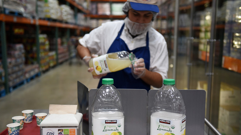 Costco employee pouring lemonade samples