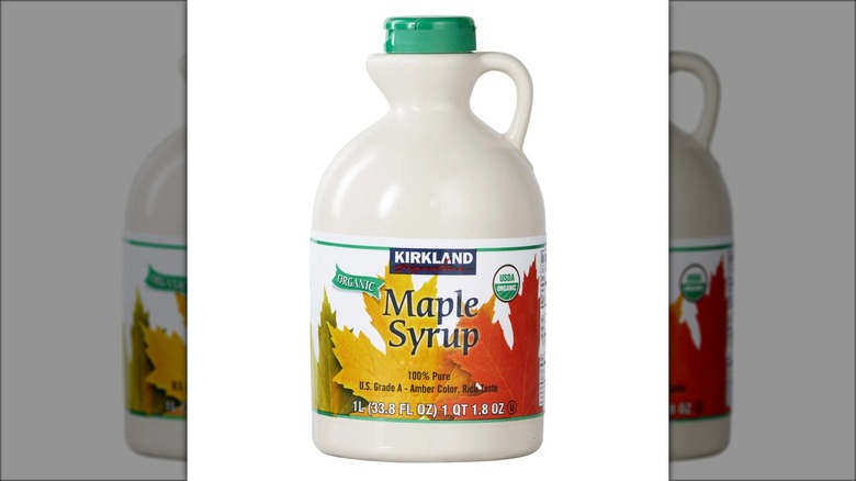 1-liter jug of Kirkland Signature 100% pure maple syrup against white background.