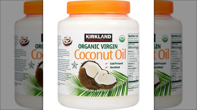 84-ounce tub of Kirkland Signature organic virgin coconut oil against white background.