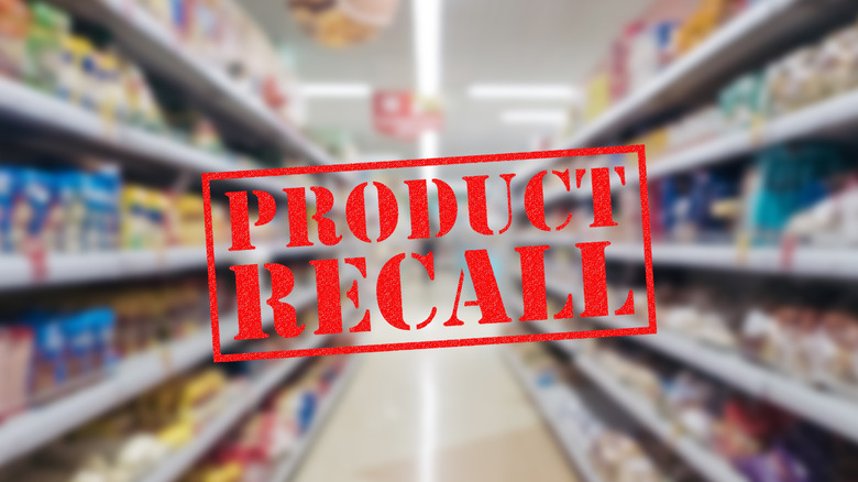 graphic with product recall stamp superimposed over blurry grocery store background