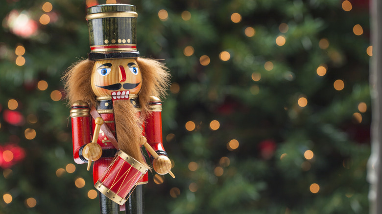 Christmas nutcracker in front of tree