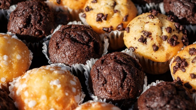 Three varieties of muffins in rows.