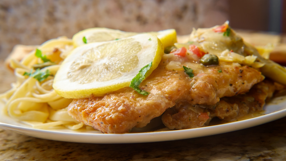 Plate of chicken piccata on pasta