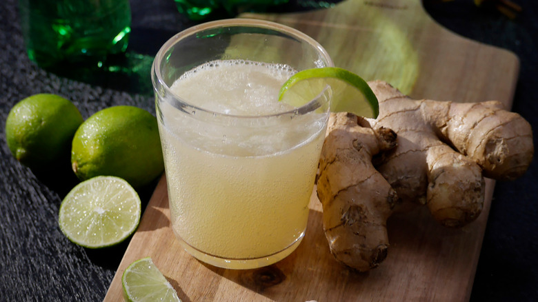 A glass of ginger beer with lime wedge