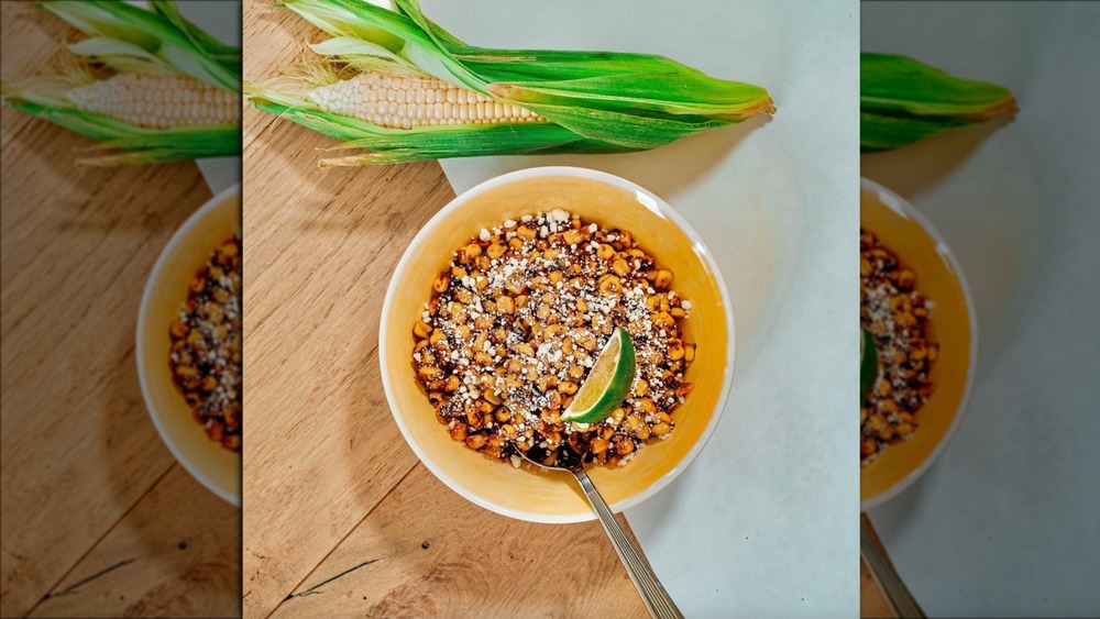 Tattooed Chef Mexican-style street corn in a bowl with lime