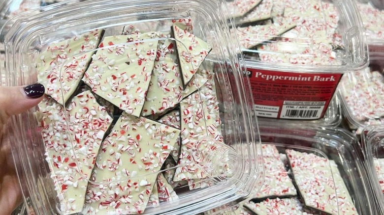 Hand holding boxes of Peppermint Bark