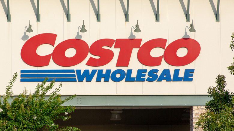 Costco sign with trees in the background