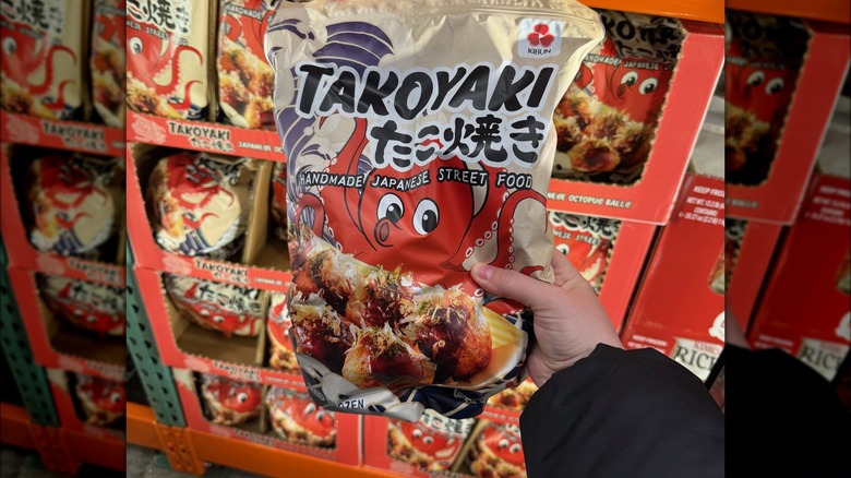 Hand holding back of frozen takoyaki bag