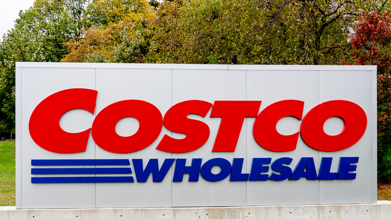 Costco sign with trees in the background