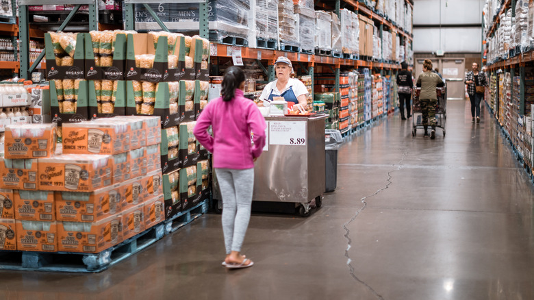 A shopper approaches the free sample cart inside Costco