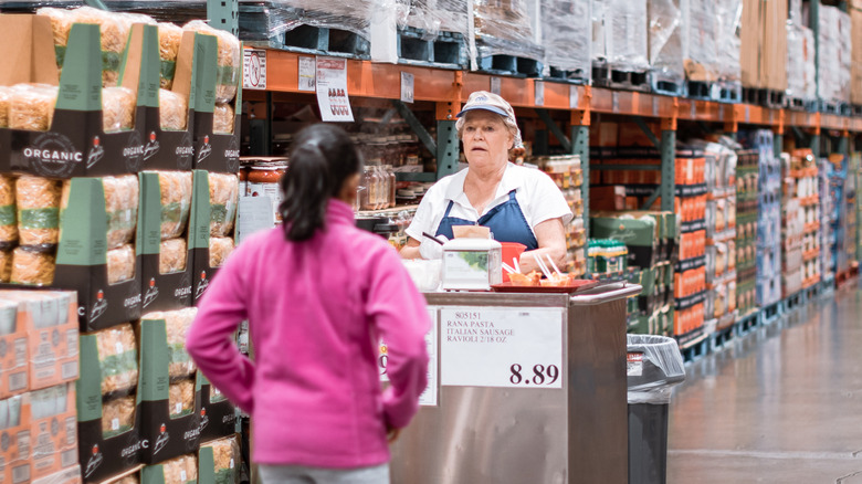 Person considering sample at Costco